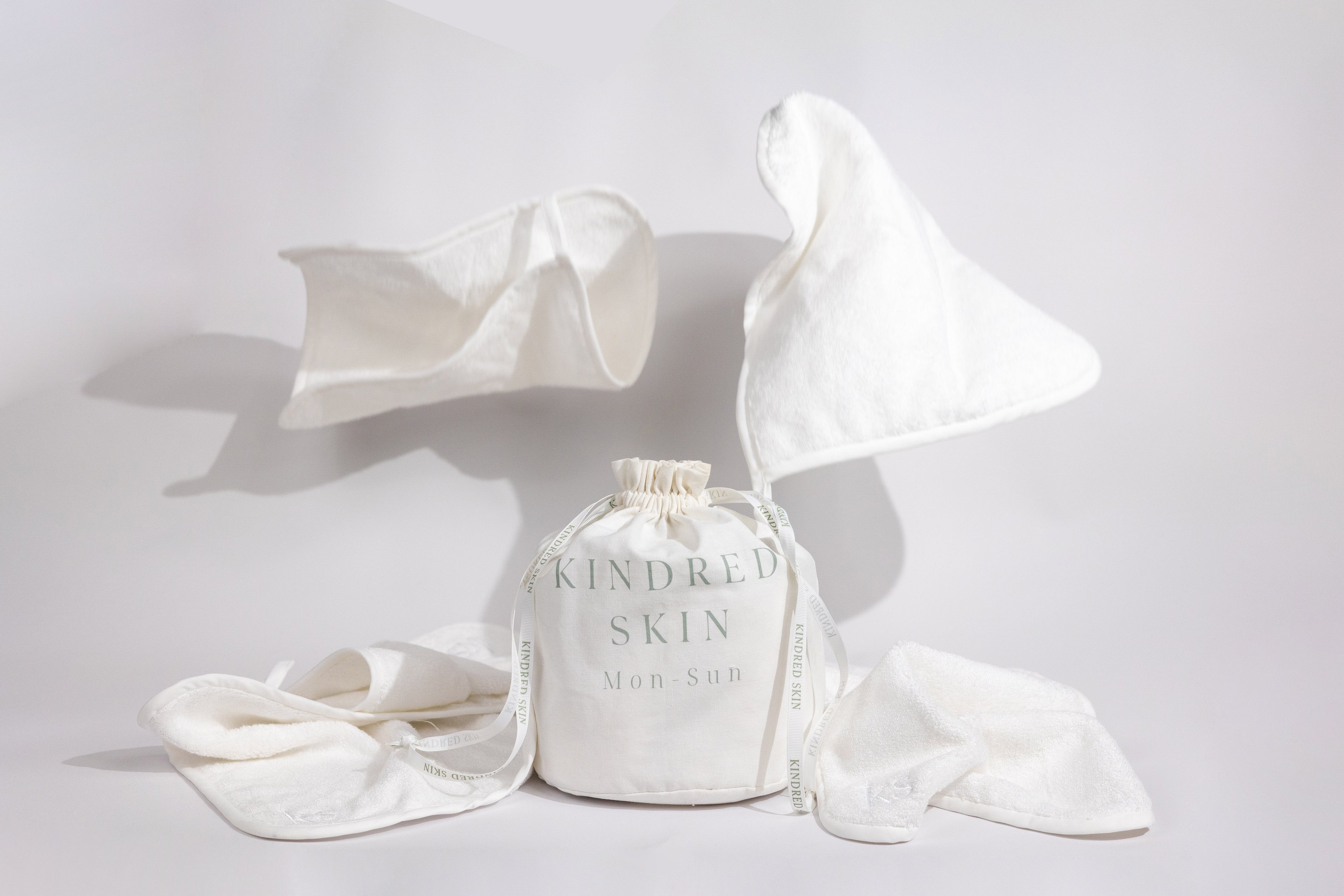 Antibacterial Bamboo Face Towels - Eco-friendly & Luxurious Skincare Essential in a bamboo back with ribbons sitting in bathroom for your basic needs 7 towels in laundry bag