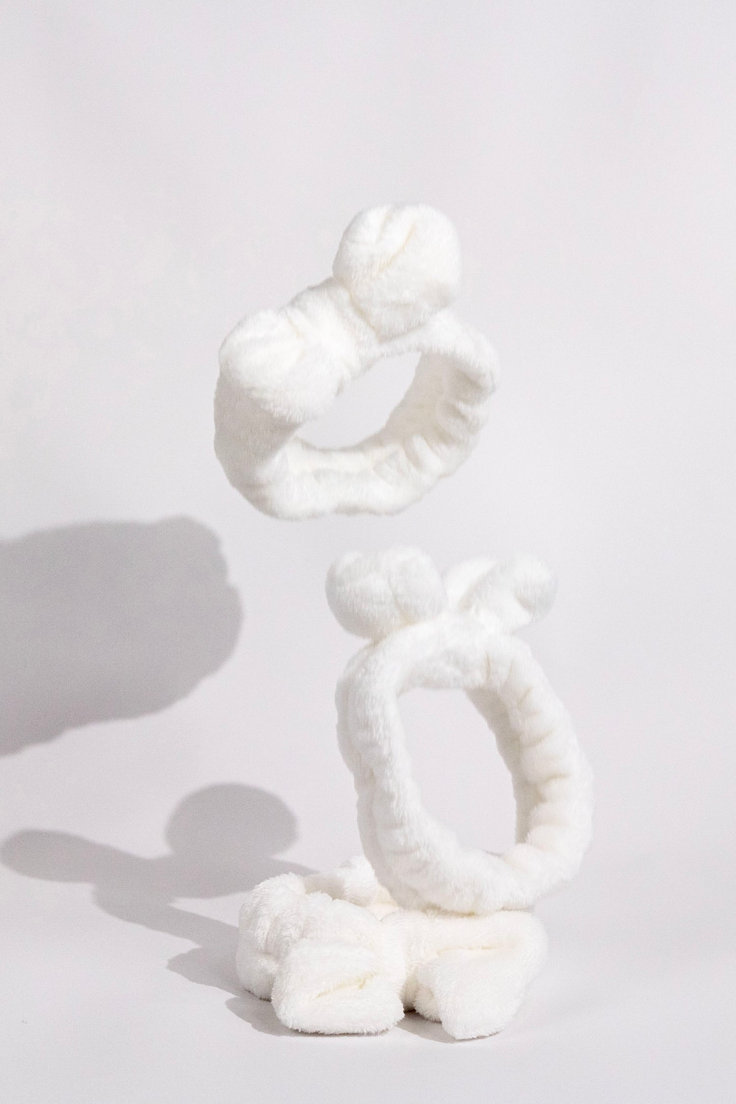 fluffy white ks kindred skincare headband to use for skincare routine to wash face with and keep hair back floating in the air product photo Comfortable Headbands for Your Skincare Routine - Australian Brand